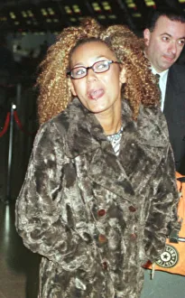Mel B of the Spice Girls showing the two rings in her tongue as she went through Heathrow