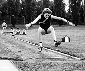 Athlete Prints: Melanie Moore throws her arms wide and bids for height and length in her long jump