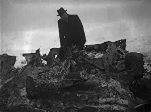 Wreckage Prints: A member of the air Intelligence branch of the war office inspect the wreckage of a