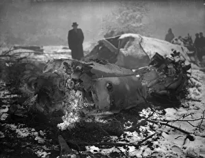 A member of the air Intelligence branch of the war office inspect the wreckage of a