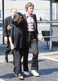 Former member of The Beatles pop group John Lennon with his wife Yoko Ono at Heathrow