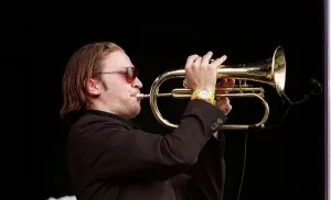 00163 Prints: Member of the Fun Loving Criminals on stage playing the trumpet at T in the Park July