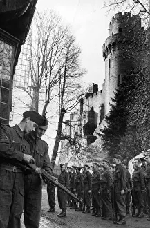 Member of the Home Guard loading his shotgun with cartridges on patrol outside Warwick