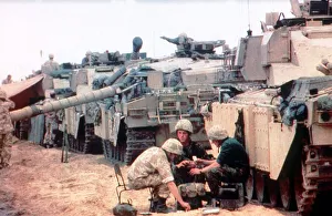 Members of the 7th Armoured Brigade prepare their challenger tanks before the start of
