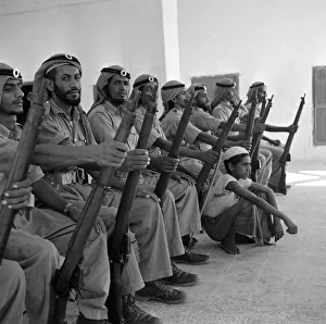 Middle East Prints: Members of the Abu Dhabi defence force pose for the camera with a young boy in