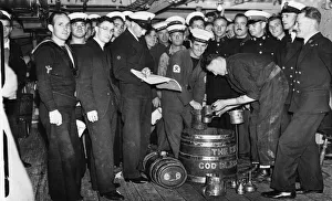 Members of the Ajax crew wait for their daily rum ration shortly after their arrival in