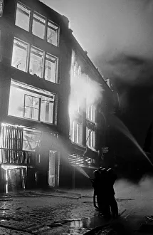 Smoke Prints: Members of the Auxiliary Fire Service and London Fire Brigade seen here fighting a fire