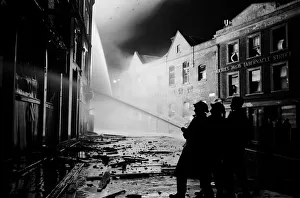 01496 Prints: Members of the Auxiliary Fire Service and London Fire Brigade seen here fighting a fire