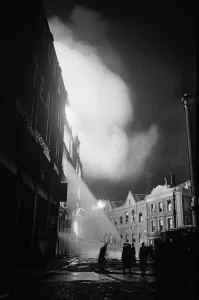 01496 Prints: Members of the Auxiliary Fire Service and London Fire Brigade seen here fighting a fire