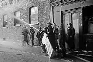 Members of the Auxiliary Fire Service and London Fire Brigade seen here fighting a fire