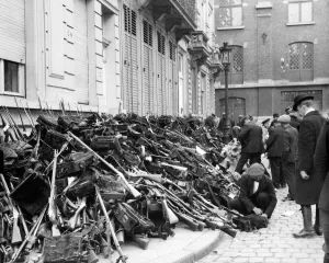 00118 Prints: Members of the Civic Guard pile arms and equipment before the Germans enter the city of
