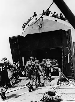 01204 Prints: Members of a combat engineer unit march abroad an LST at an English port