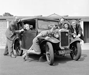 Members of the Goul family give grandmas car a push start Circa 1957
