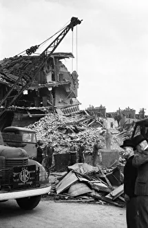 Members of the LCC salvage squad and members of the ARP search the rubble of a V1