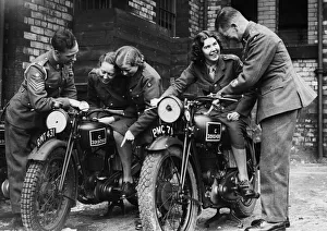 Members of the W. A. T.s learn a little about motorcycling from soldier at a Manchester