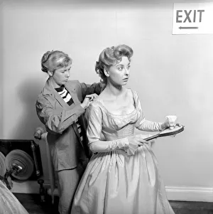 Members of the Wardrobe and make-up departments at Pinewood Studios help the actresses
