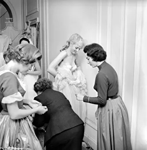 Members of the Wardrobe and make-up departments at Pinewood Studios help the actresses