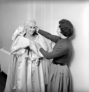 00790 Prints: Members of the Wardrobe and make-up departments at Pinewood Studios help the actresses