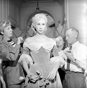 Members of the Wardrobe and make-up departments at Pinewood Studios help the actresses