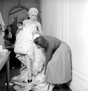00790 Prints: Members of the Wardrobe and make-up departments at Pinewood Studios help the actresses