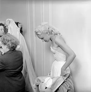 00790 Prints: Members of the Wardrobe and make-up departments at Pinewood Studios help the actresses