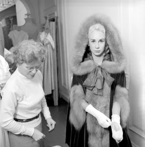 Members of the Wardrobe and make-up departments at Pinewood Studios help the actresses