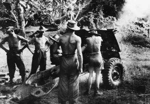 01455 Prints: Men of the 36th Infantry Division firing a 25-pdr field gun in the Burmese jungle against