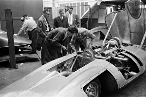 Automobile Prints: Men, including Syd Enever, looking at the MG EX181 which is being worked