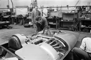 Automobile Prints: Men, including Syd Enever and Tommy Wisdom looking at the MG EX181 which is being worked
