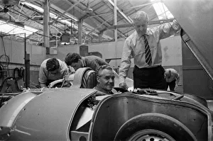 Men, including Syd Enever and Tommy Wisdom looking at the MG EX181 which is being worked