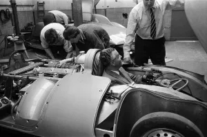 01303 Prints: Men, including Syd Enever and Tommy Wisdom looking at the MG EX181 which is being worked