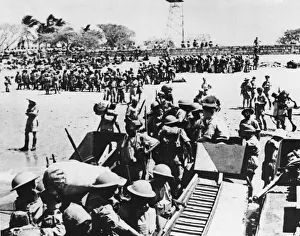 01465 Prints: Men of the Kings African Rifles assembled in their steel helmets on the beach