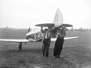 01411 Prints: Two men manually transporting a Chilton DW1A across the field at Bagington Circa 1955