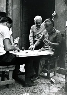 Men playing cards outdoors in Naples Italy - June 1962