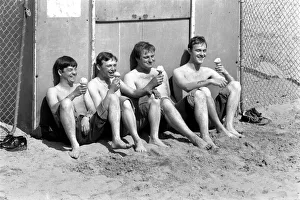 Swimming Trunks Prints: Four men sitting enjoying an ice cream in the hot weather at Margate Beach