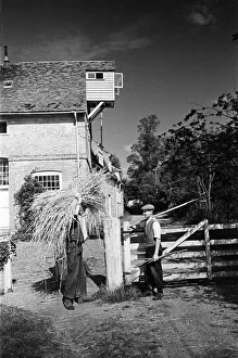 Two men at work at Flatford Mill, on the River Stour close to the Suffolk-Essex border