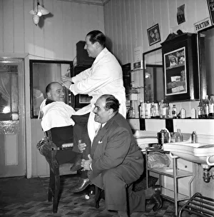 Barbers Prints: Mens Barbers Shop: Mr. Thomas the barber seen here having a joke with some of his