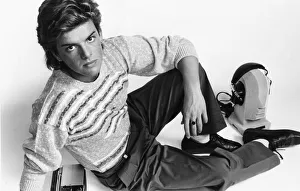 Mens Fashions Spring 1985. Our model wears stripe knitwear jumper pleated trousers tucked