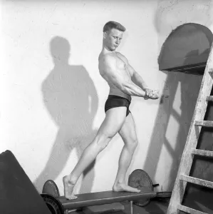 Mens Health: Body builder Larry Stevens seen here posing in the gym. 1957