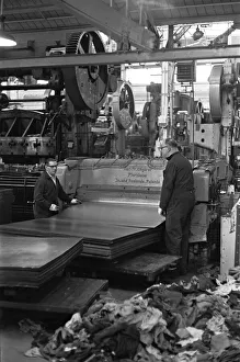 Team Work Prints: Metal sheets are fed into the body panel press at the The Austin Mini production line