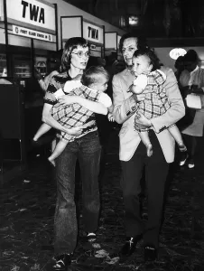 00144 Prints: Mia Farrow Actress with husband and twin sons at Heathrow airport Dbase MSI