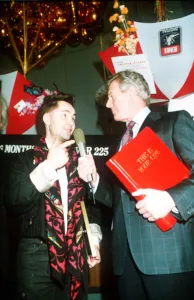 Michael Aspel TV Presenter of This is your Life surprising Nigel Kennedy holding red book