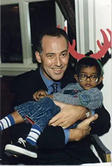 MICHAEL BARRYMORE, COMEDIAN, HOLDING A LITTLE BOY 15 / 12 / 1993
