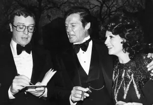 Tuxedo Prints: Michael Caine and Roger Moore with third wife Luisa At film premiere Shout