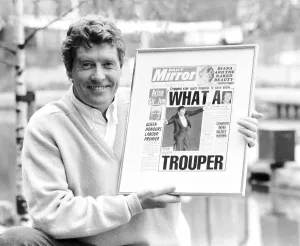 Michael Crawford holds up a framed front page of the Daily Mirror June 1987