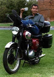 Actions Prints: Michael Elphick actor sitting on motorbike holding cup of tea