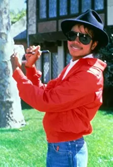 Images Dated 1st April 1984: Michael Jackson signing his autograph at his home. April 1984