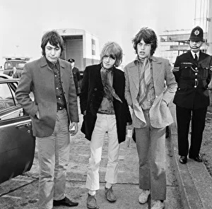Police Officer Prints: Mick Jagger, Brian Jones and Charlie Watts seen here at London Airport after their