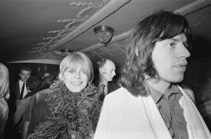 Mick Jagger, lead singer of the Rolling Stones pop group with his girlfriend Marianne