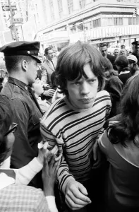 Mick Jagger of The Rolling Stones surrounded by fans on Broadway. 2nd June 1964
